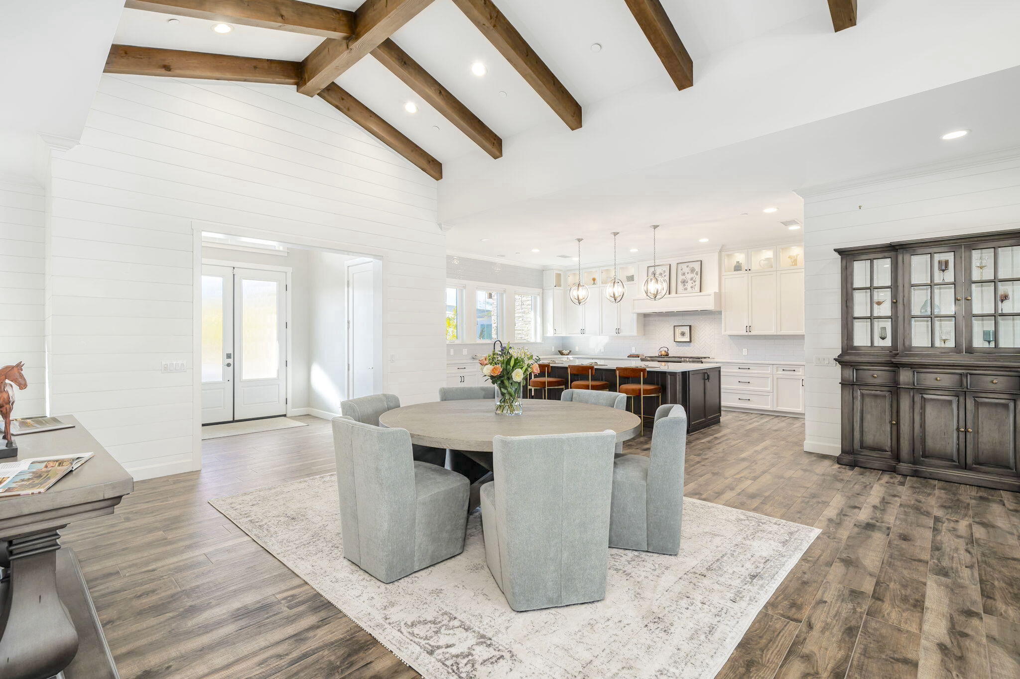 a dining hall with stainless steel appliances kitchen island granite countertop a sink and cabinets