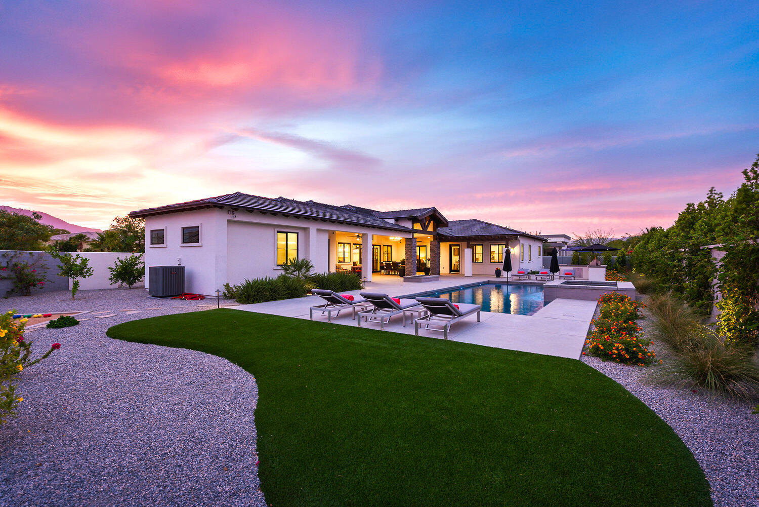 7 Siena Vista Rancho Mirage, CA 92270 - Photo 23 of 26 a view of a house with a big yard couches and table and chairs with wooden fence