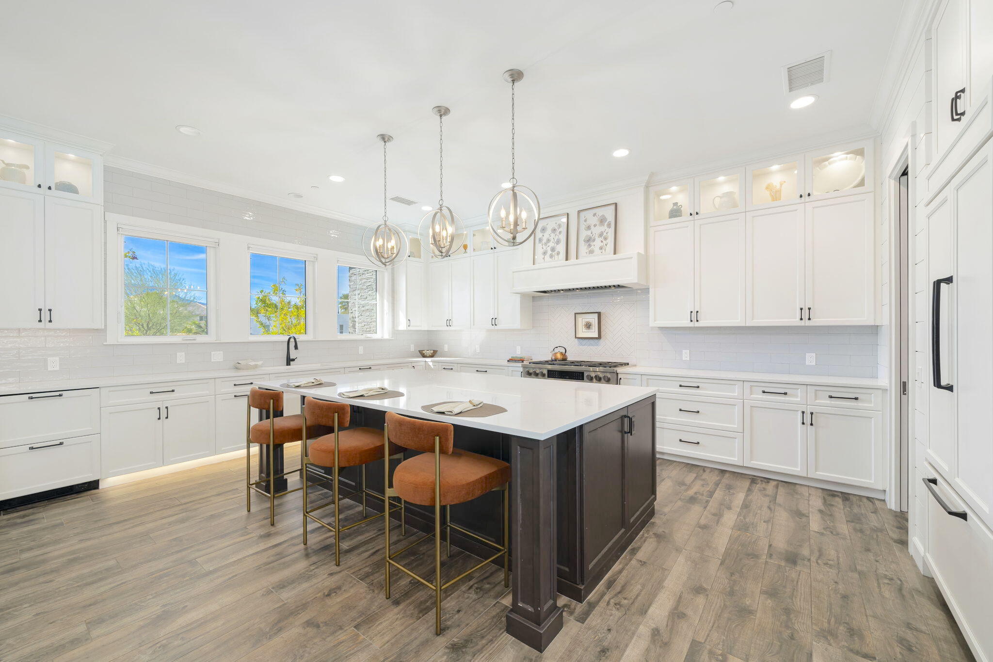 7 Siena Vista Rancho Mirage, CA 92270 - Photo 6 of 26 a kitchen with stainless steel appliances granite countertop a sink a stove a refrigerator and island with wooden floor
