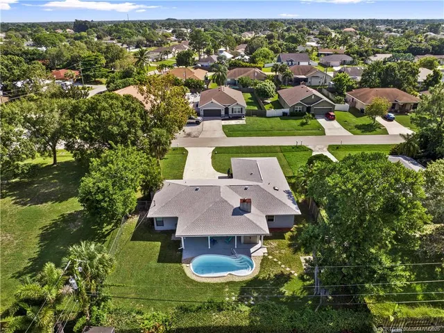 an aerial view of a house with yard swimming pool and outdoor seating
