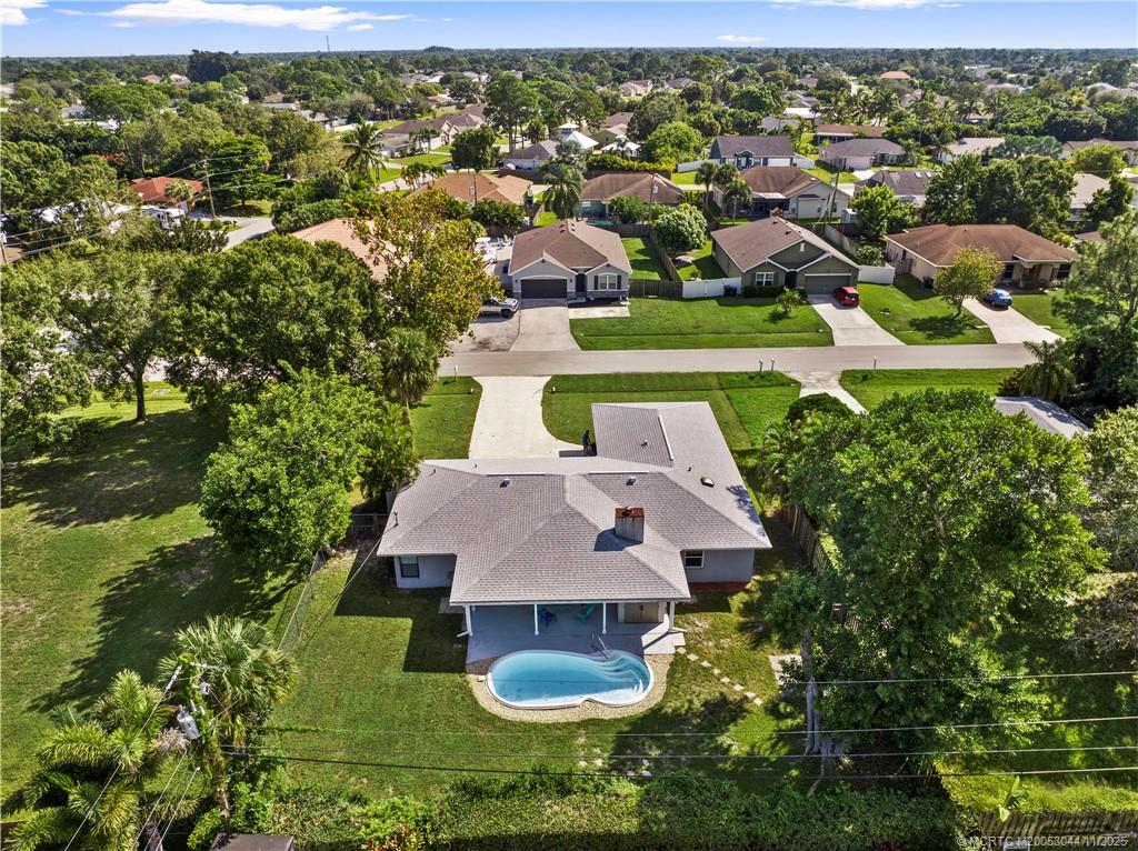 an aerial view of a house with yard swimming pool and outdoor seating