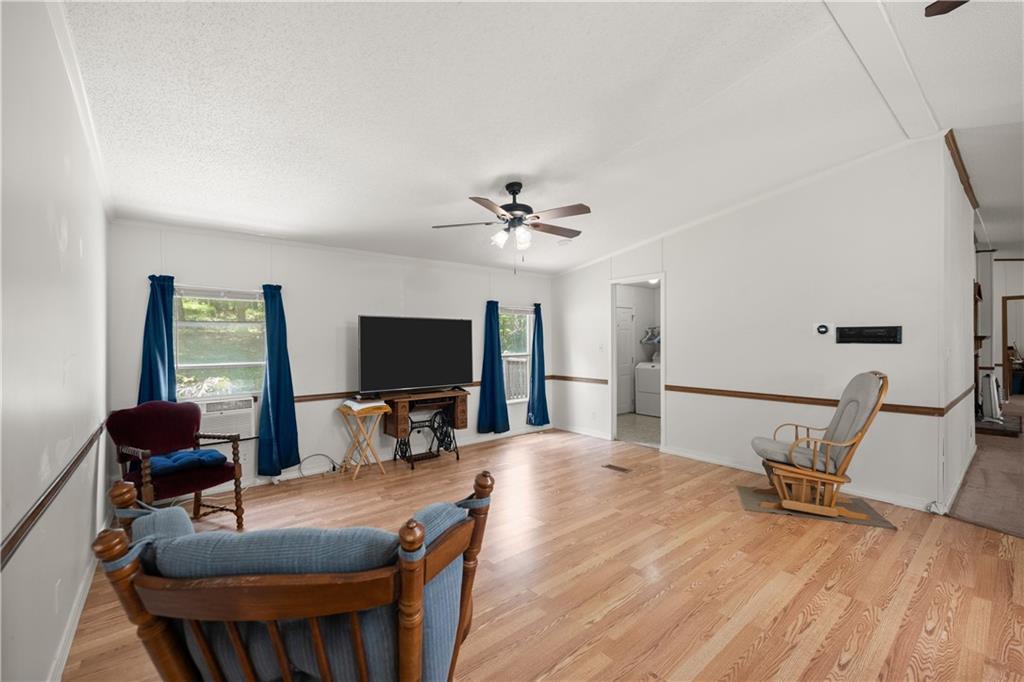 1000 Jim Johnson Road Northwest Winder, GA 30680 - Photo 12 of 37 a living room with furniture and a flat screen tv