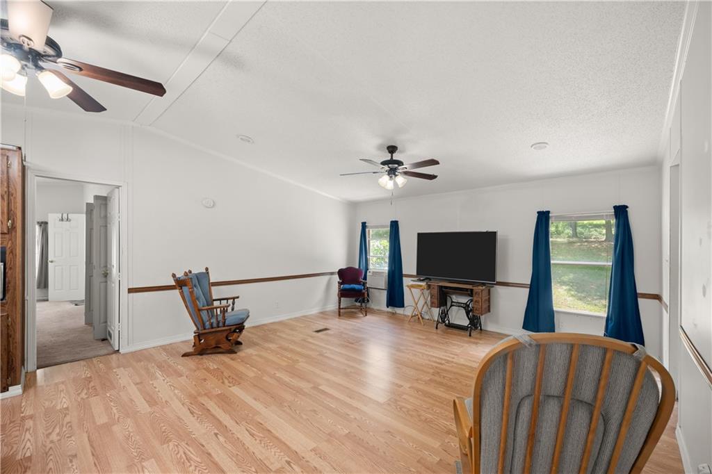 1000 Jim Johnson Road Northwest Winder, GA 30680 - Photo 13 of 37 a bedroom with a bed and a flat tv screen on the dresser