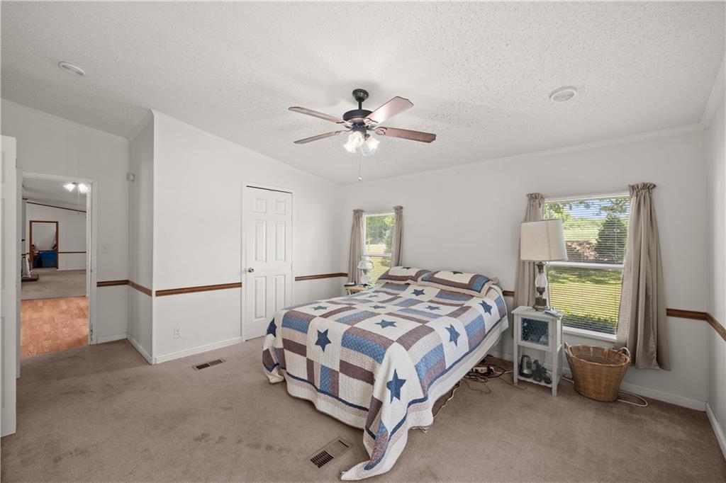 1000 Jim Johnson Road Northwest Winder, GA 30680 - Photo 15 of 37 a bed sitting in a spacious bedroom next to a window