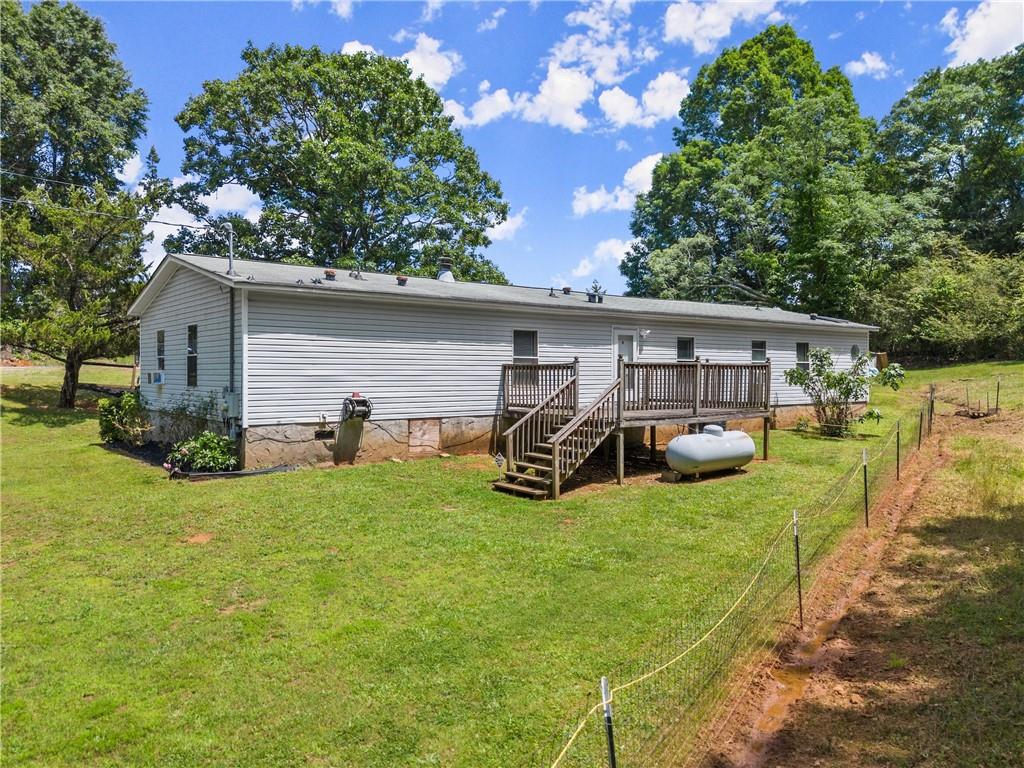 1000 Jim Johnson Road Northwest Winder, GA 30680 - Photo 25 of 37 a view of a house with a yard and sitting area