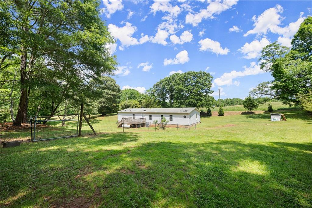1000 Jim Johnson Road Northwest Winder, GA 30680 - Photo 27 of 37 a swimming pool with outdoor seating and yard