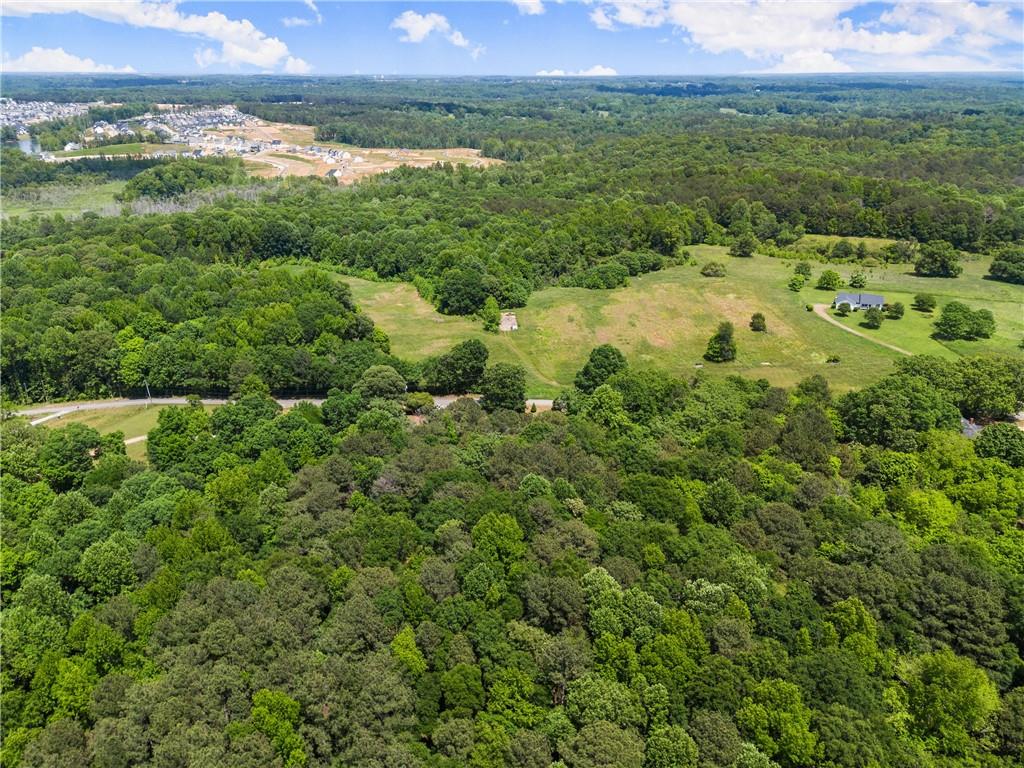 1000 Jim Johnson Road Northwest Winder, GA 30680 - Photo 32 of 37 a view of a lush green forest with a houses