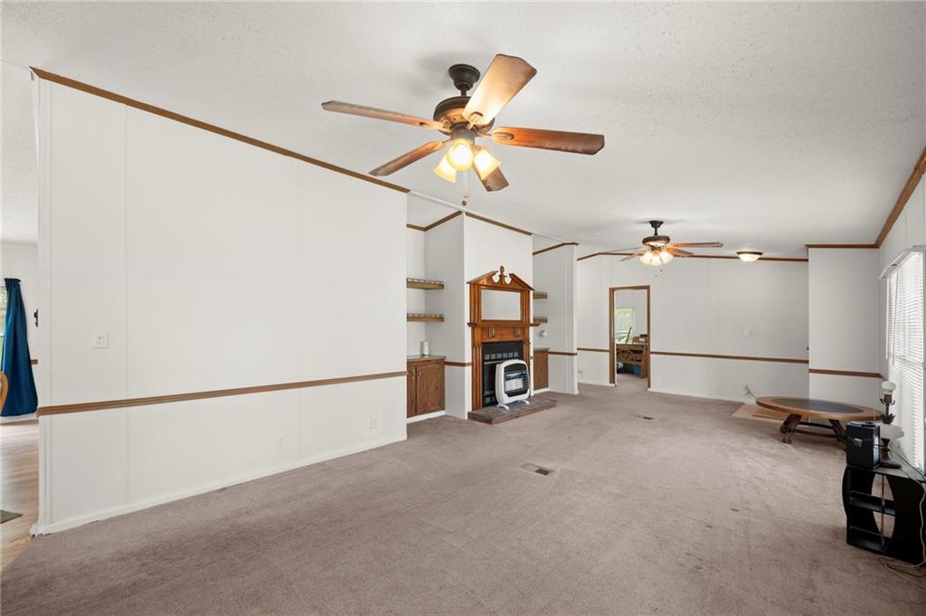 1000 Jim Johnson Road Northwest Winder, GA 30680 - Photo 5 of 37 a view of a livingroom with a ceiling fan and window