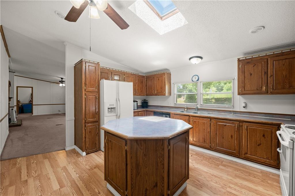 1000 Jim Johnson Road Northwest Winder, GA 30680 - Photo 7 of 37 a kitchen with stainless steel appliances granite countertop a sink stove and refrigerator