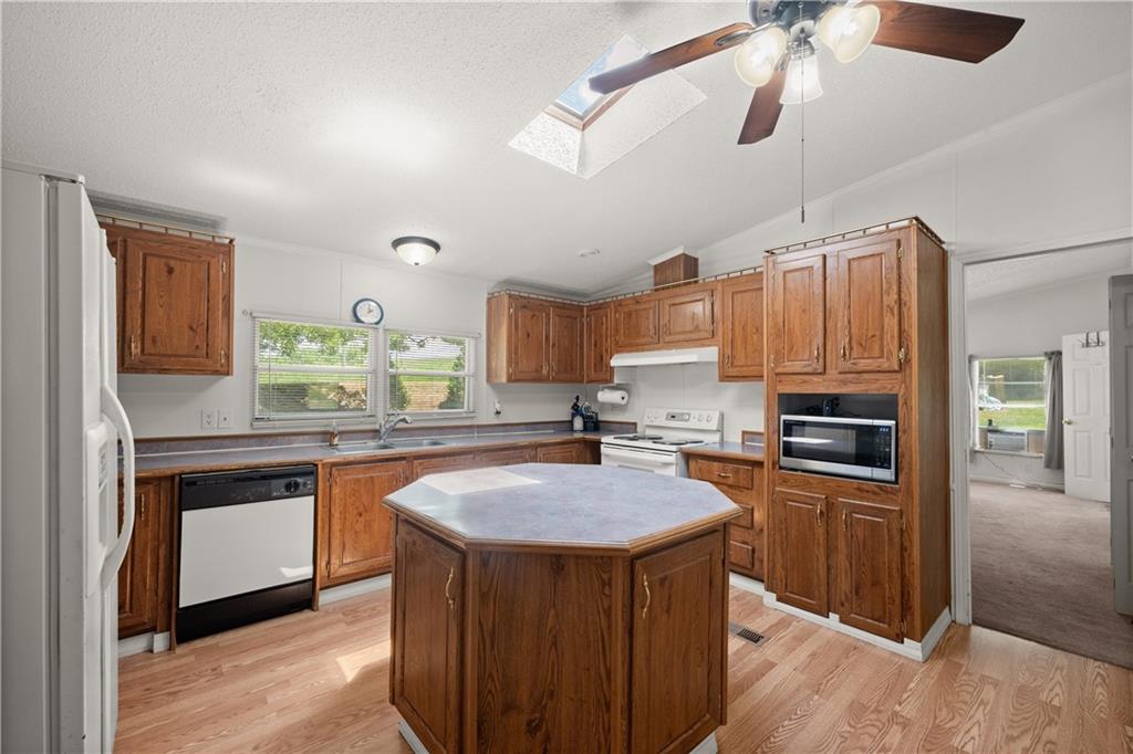 1000 Jim Johnson Road Northwest Winder, GA 30680 - Photo 10 of 37 a kitchen with granite countertop a sink appliances and cabinets