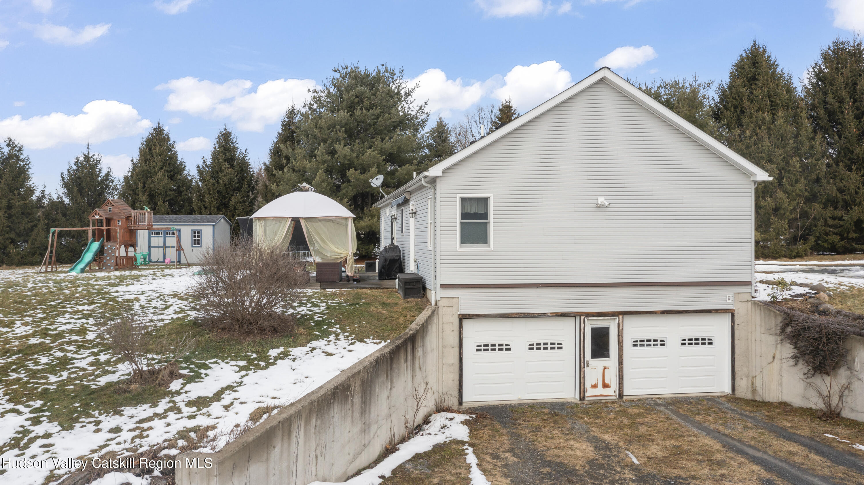 490 Talerico Road Ghent, NY 12075 - Photo 23 of 24 a view of a white house next to a yard with big trees
