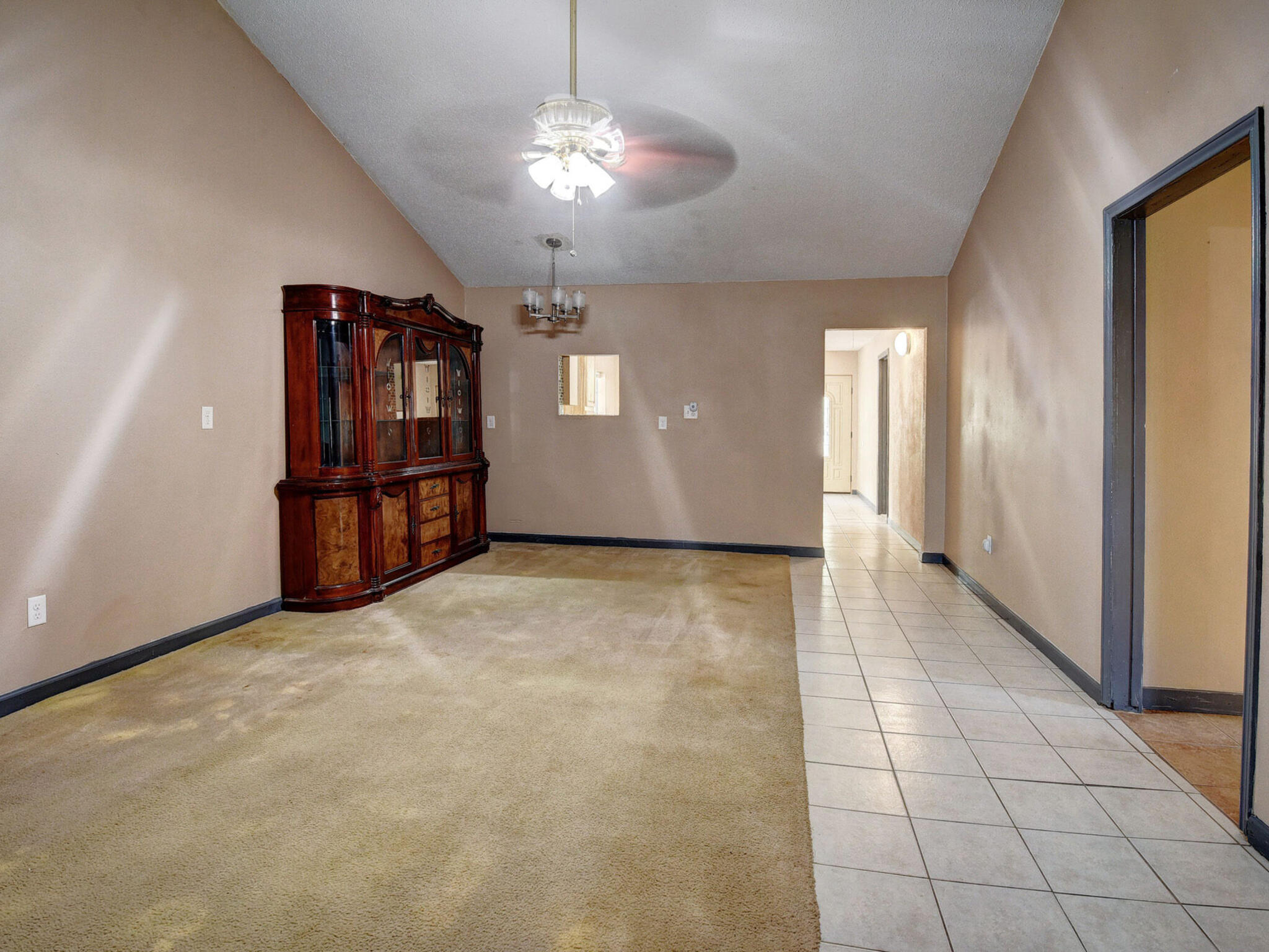 176 Lacy Drive Elgin, TX 78621 - Photo 12 of 40 an empty room with chandelier and windows