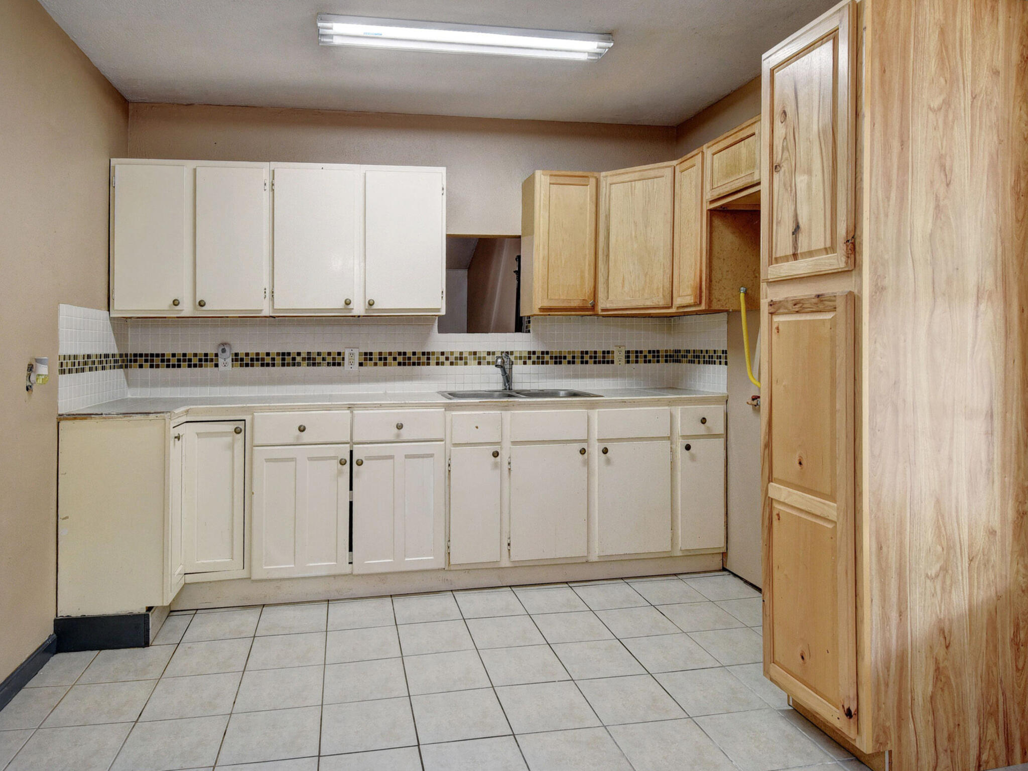 176 Lacy Drive Elgin, TX 78621 - Photo 17 of 40 a kitchen with white cabinets and appliances