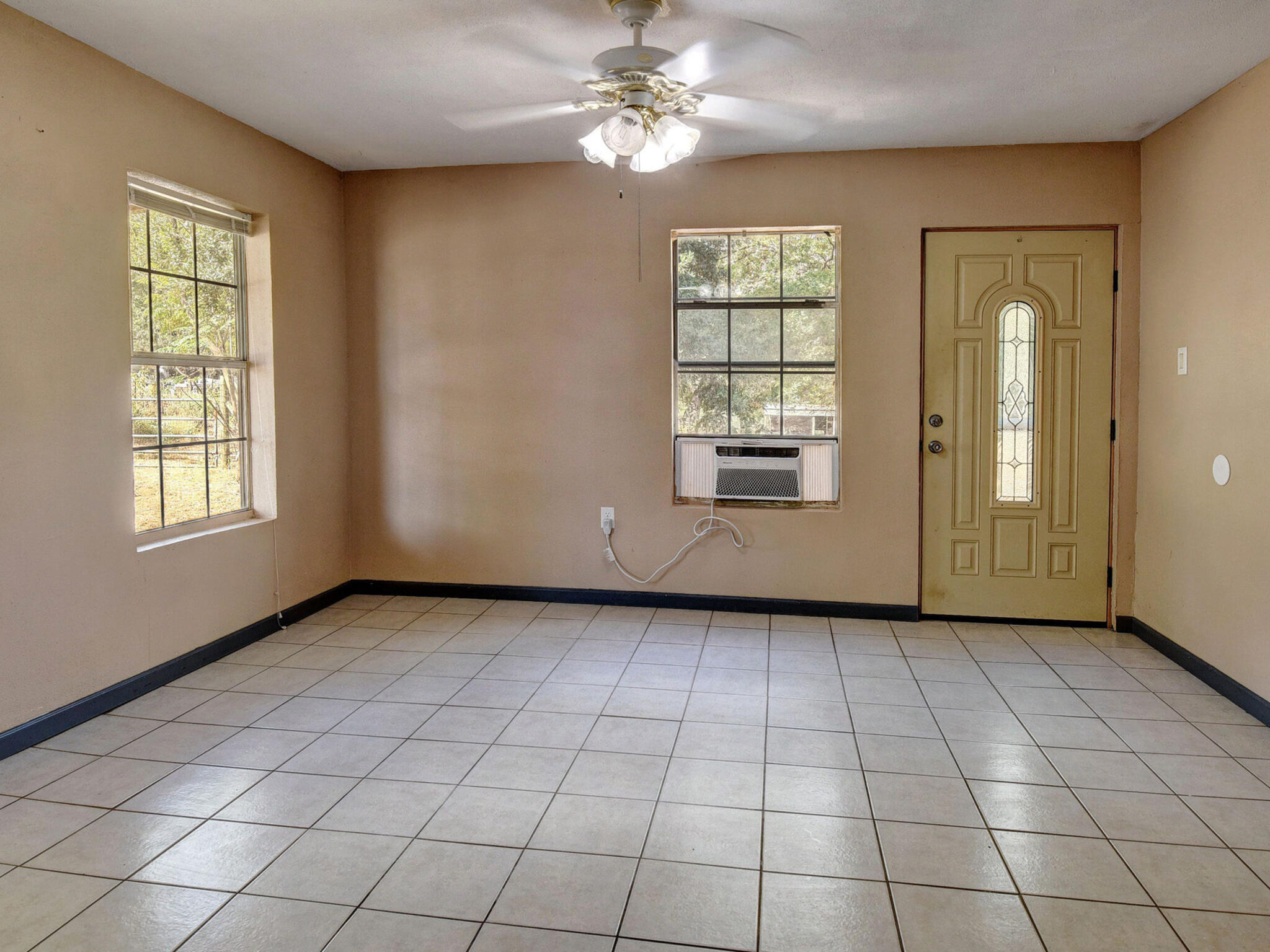 176 Lacy Drive Elgin, TX 78621 - Photo 18 of 40 an empty room with windows and fan