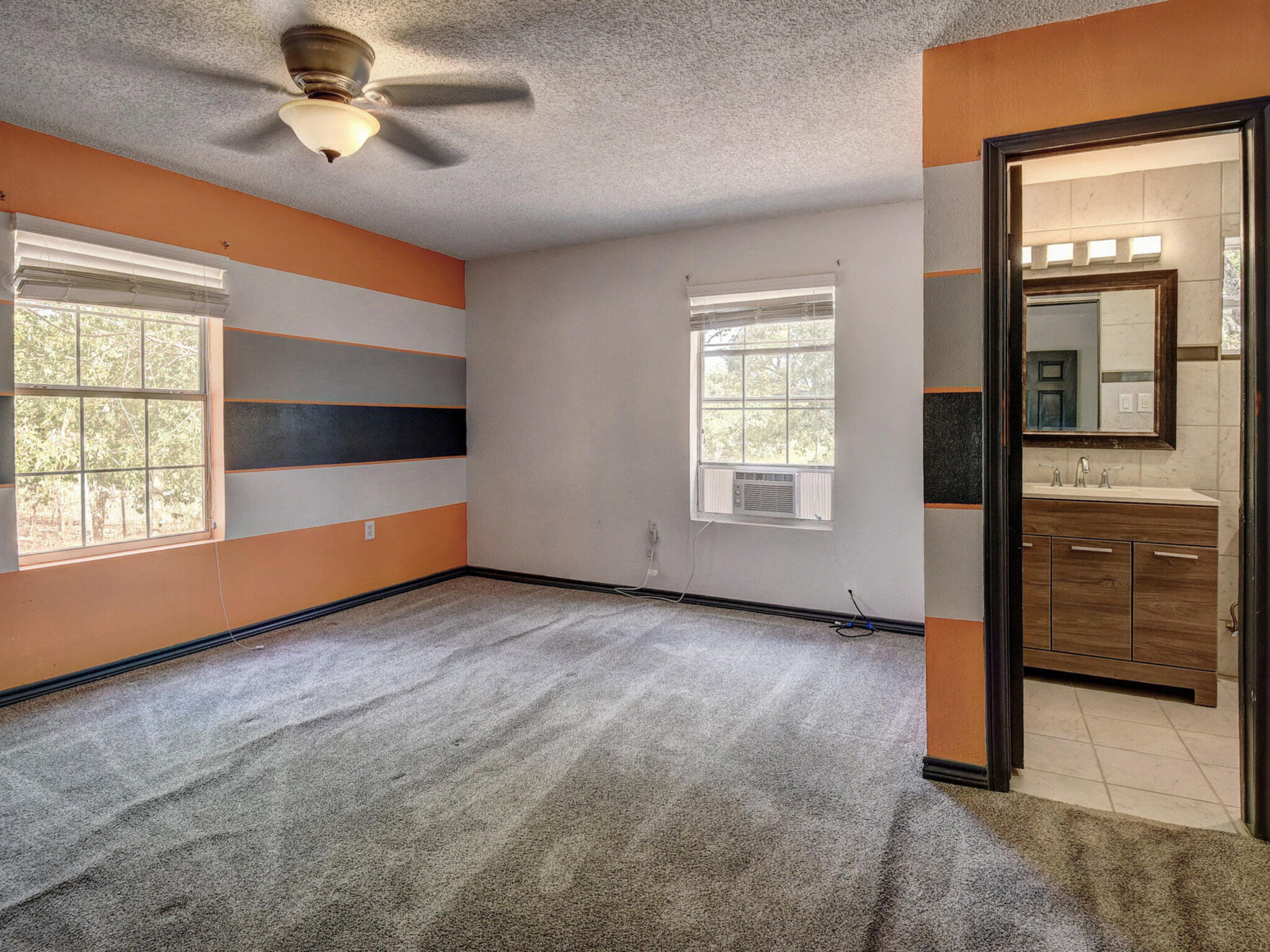 176 Lacy Drive Elgin, TX 78621 - Photo 20 of 40 en empty room with windows and ceiling fan