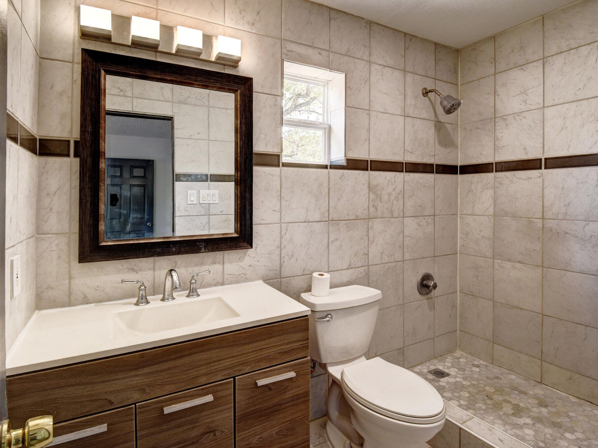 176 Lacy Drive Elgin, TX 78621 - Photo 22 of 40 a bathroom with a sink a toilet a mirror and shower