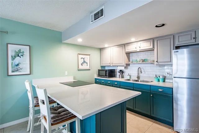 a kitchen with refrigerator cabinets dining table and chairs