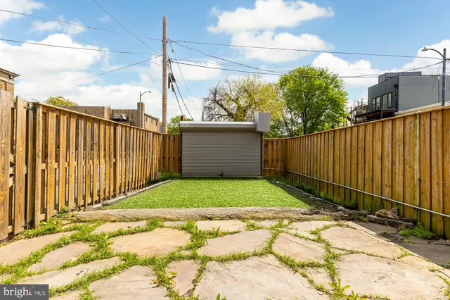 a view of a backyard with fence