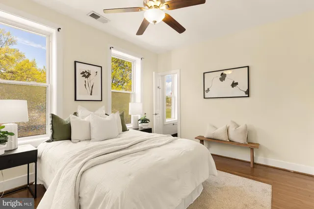 a bedroom with a bed and painting on the wall