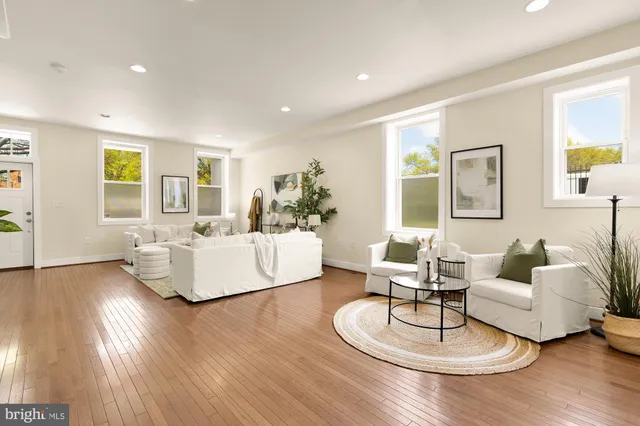 a living room with furniture and wooden floor