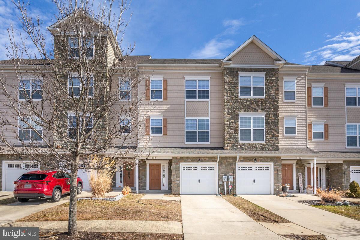 102 Backstretch Way Prince Frederick, MD 20678 - Photo 2 of 44 a front view of a building and a yard