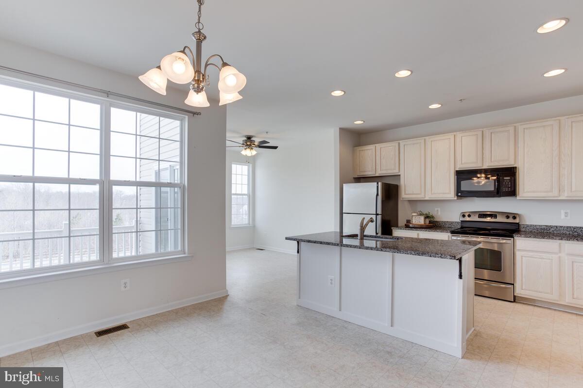102 Backstretch Way Prince Frederick, MD 20678 - Photo 11 of 44 a kitchen with stainless steel appliances granite countertop a stove and a sink