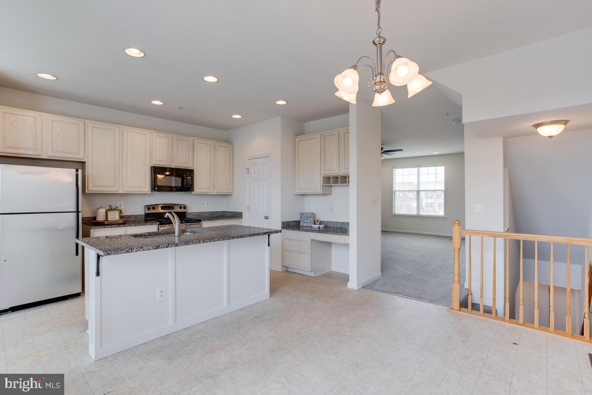 102 Backstretch Way Prince Frederick, MD 20678 - Photo 12 of 44 a kitchen with stainless steel appliances granite countertop a sink a stove a refrigerator and cabinets