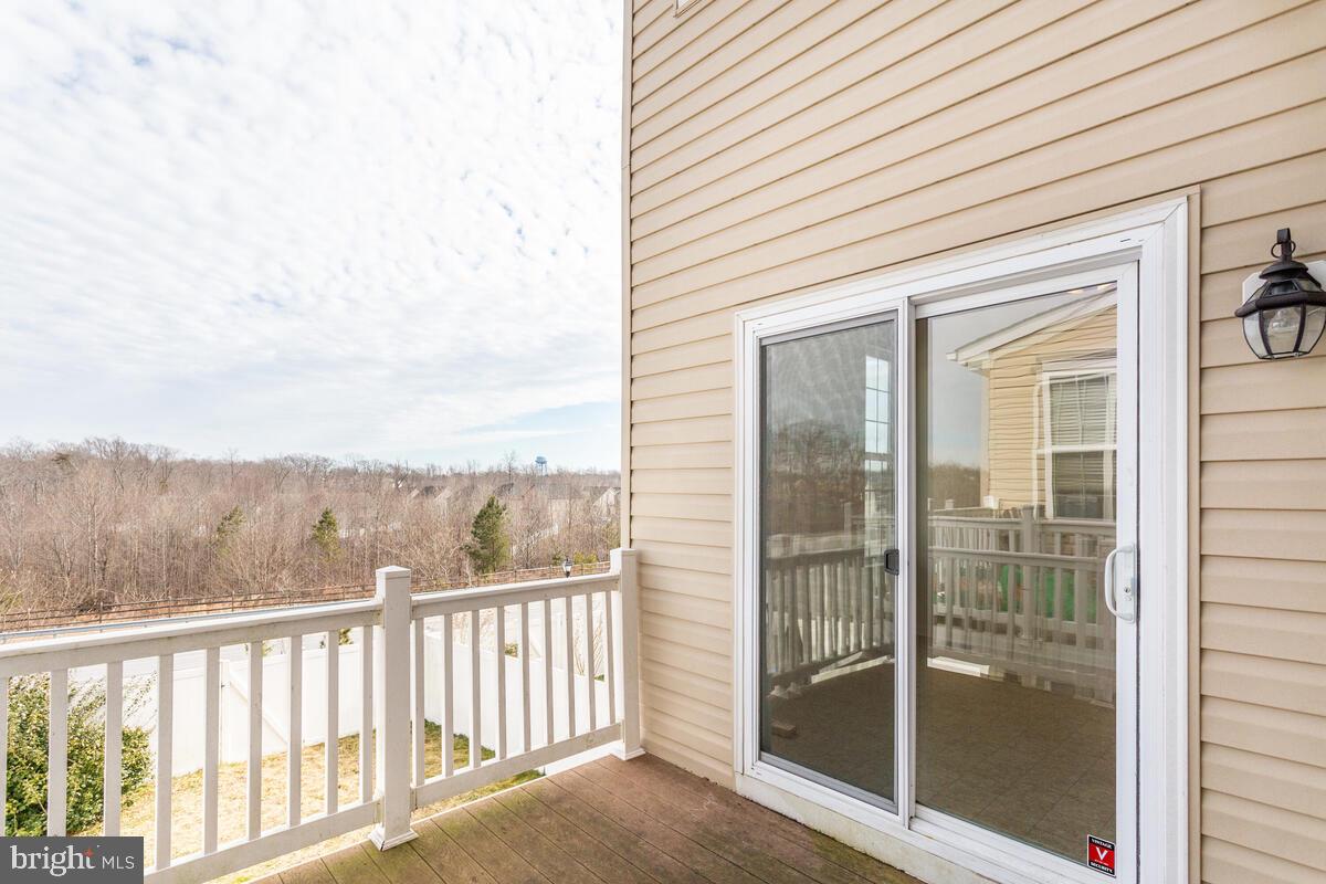 102 Backstretch Way Prince Frederick, MD 20678 - Photo 16 of 44 a view of a balcony with floor to ceiling window and wooden floor