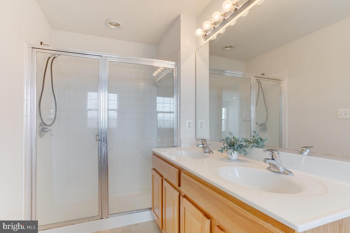 102 Backstretch Way Prince Frederick, MD 20678 - Photo 23 of 44 a bathroom with a double vanity sink mirror and double