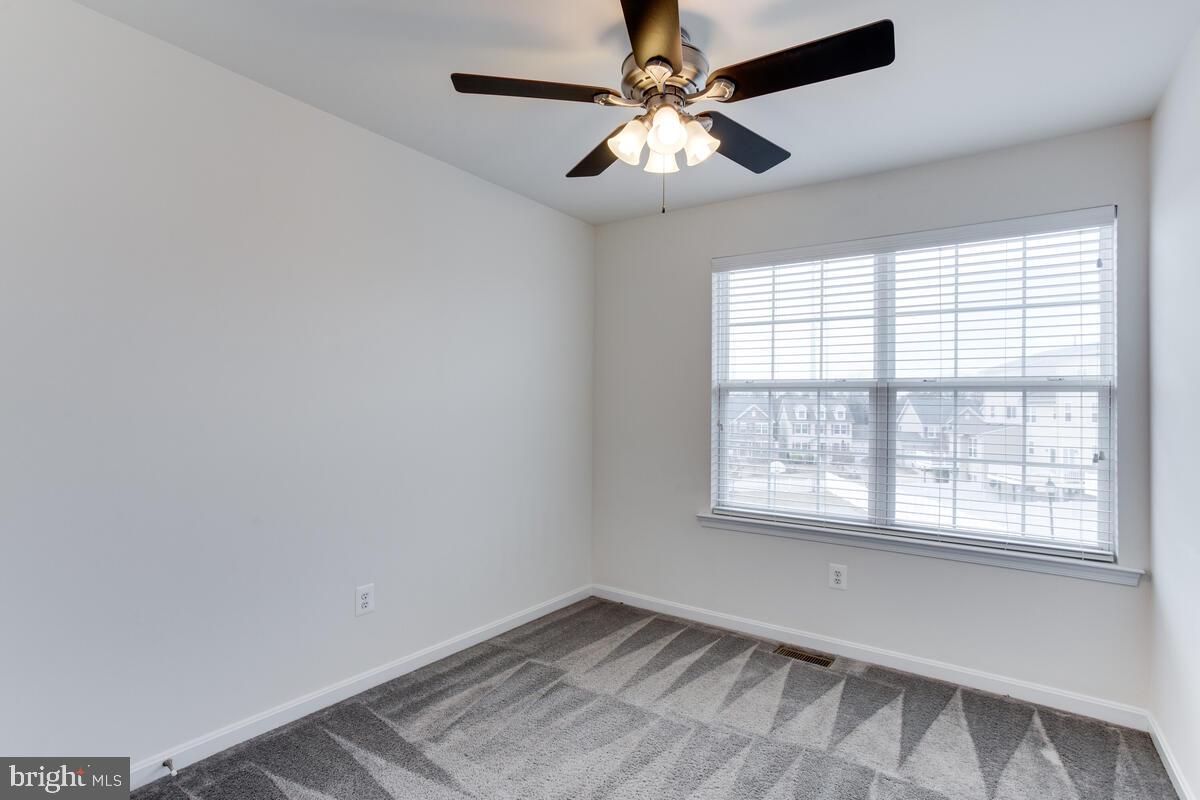 102 Backstretch Way Prince Frederick, MD 20678 - Photo 29 of 44 an empty room with a window and a fan