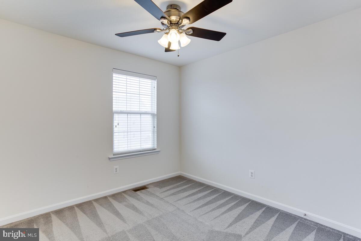 102 Backstretch Way Prince Frederick, MD 20678 - Photo 31 of 44 an empty room with windows and fan