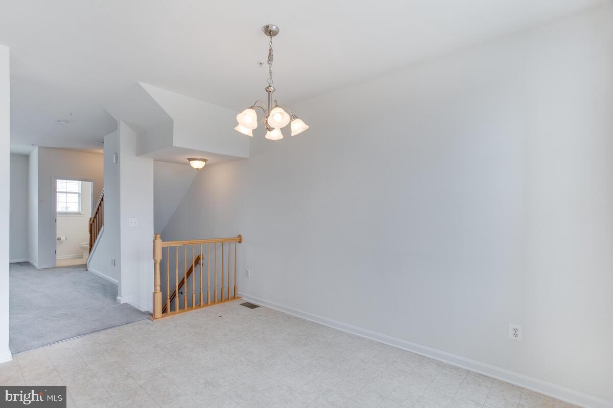 102 Backstretch Way Prince Frederick, MD 20678 - Photo 5 of 44 a view of an empty room with chandelier fan and wooden floor