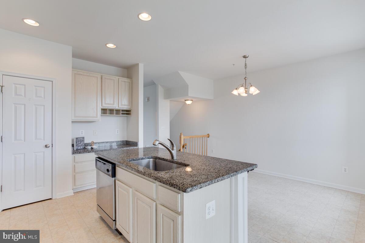 102 Backstretch Way Prince Frederick, MD 20678 - Photo 9 of 44 a kitchen with granite countertop a sink and cabinets