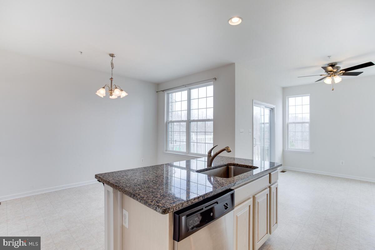 102 Backstretch Way Prince Frederick, MD 20678 - Photo 10 of 44 a kitchen with granite countertop a sink cabinets and window