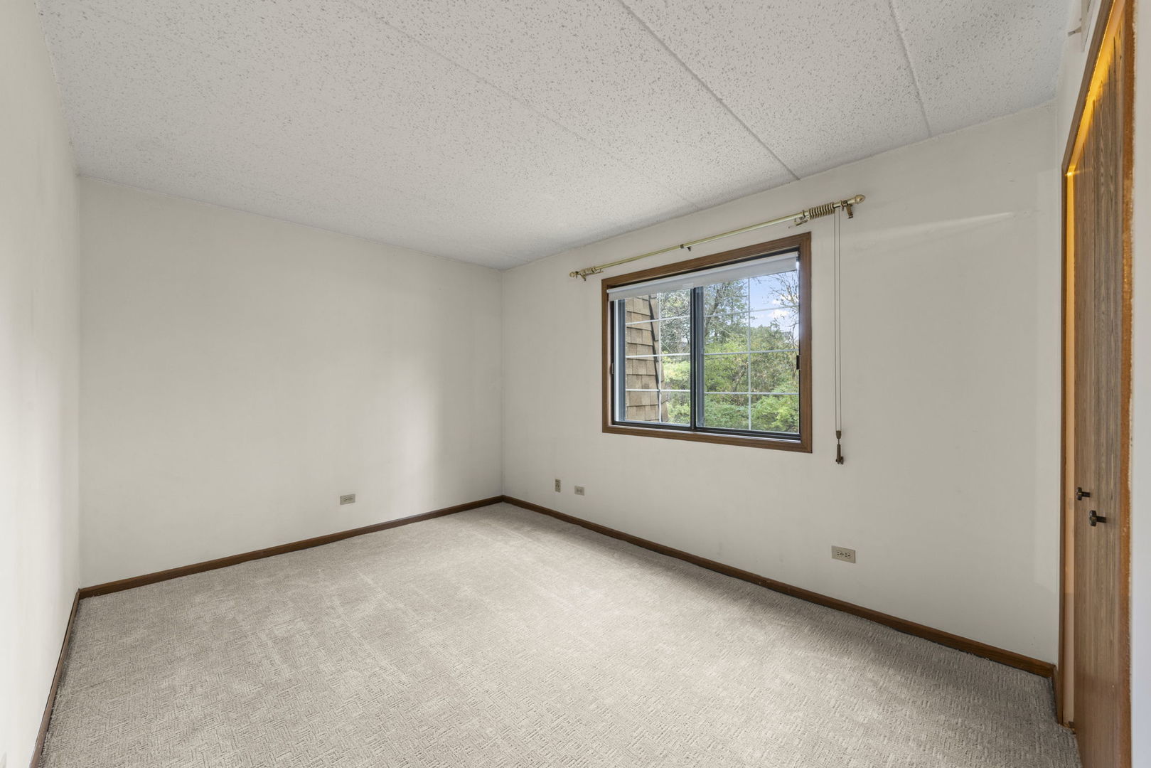 393 Duane Street, Unit 203 Glen Ellyn, IL 60137 - Photo 11 of 18 a view of an empty room with a window