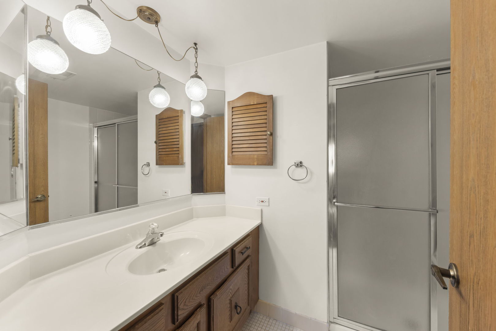 393 Duane Street, Unit 203 Glen Ellyn, IL 60137 - Photo 13 of 18 a bathroom with a sink and a mirror