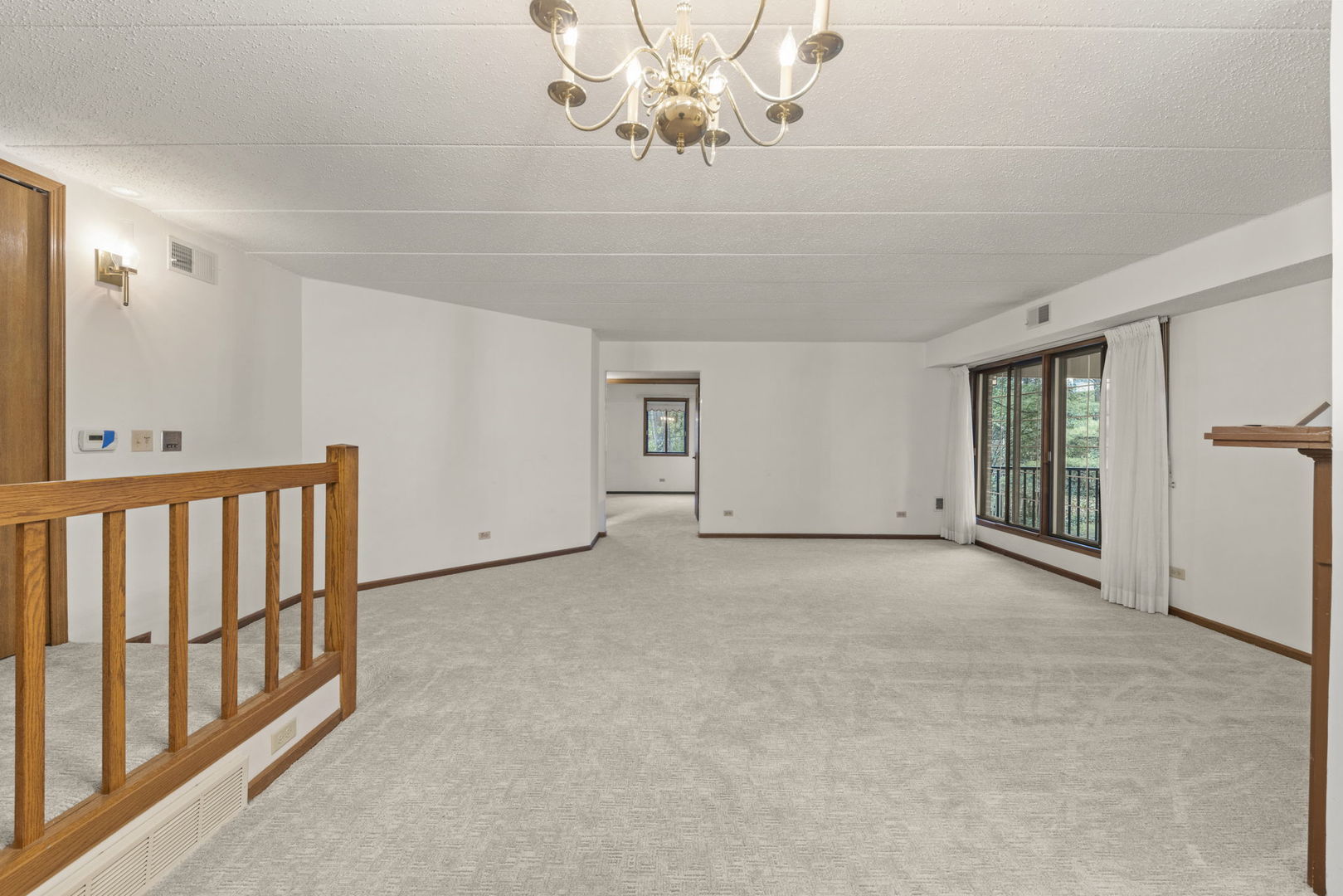 393 Duane Street, Unit 203 Glen Ellyn, IL 60137 - Photo 3 of 18 a view of an empty room with a window