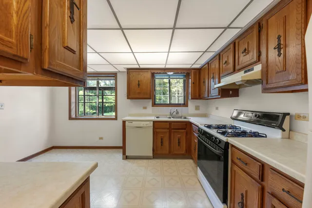 a kitchen with stainless steel appliances granite countertop a stove a sink dishwasher and a stove top oven