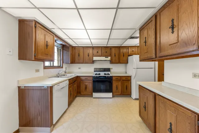 a kitchen with a stove sink and cabinets