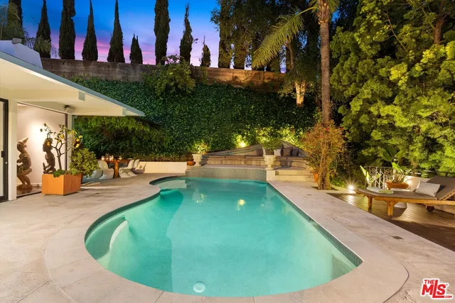 a view of a swimming pool with an outdoor seating