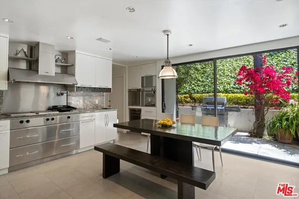 a kitchen with kitchen island a stove and a wooden floor