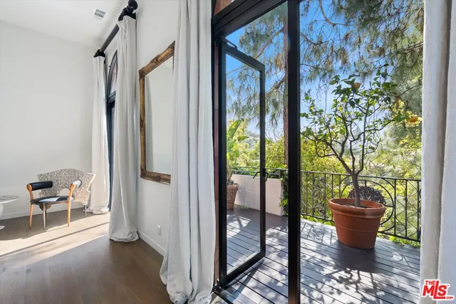 a view of a porch with furniture and garden
