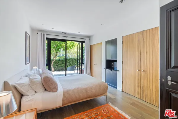 a bedroom with a bed and a large window