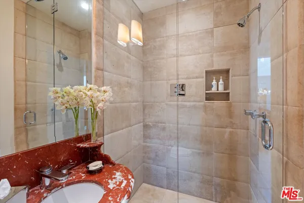 a bathroom with a sink and shower