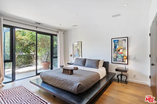 a bedroom with a large bed and a large window