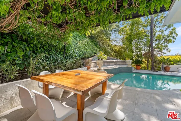 a backyard of a house with table and chairs