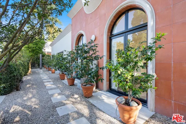 a front view of a house with potted plants