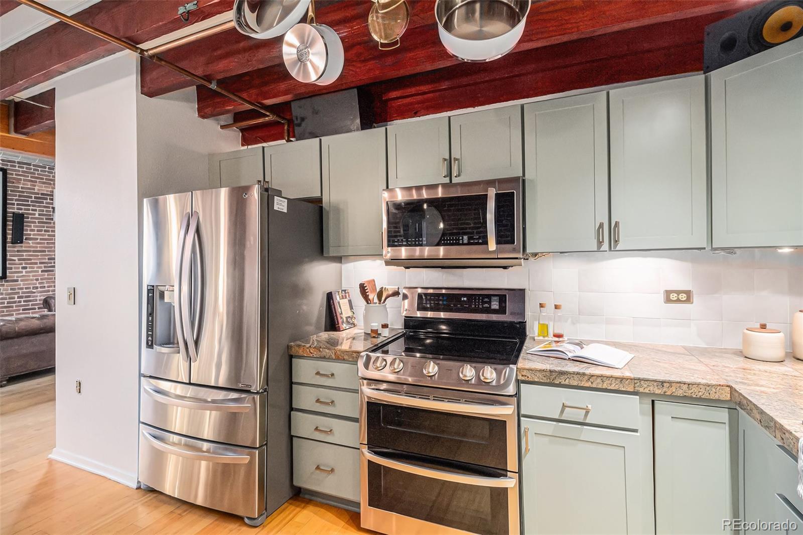 3225 Blake Street, Unit 24 Denver, CO 80205 - Photo 12 of 25 a kitchen with stainless steel appliances a stove microwave and refrigerator