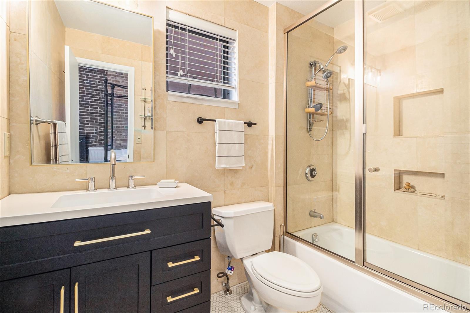3225 Blake Street, Unit 24 Denver, CO 80205 - Photo 20 of 25 a bathroom with a sink a toilet and shower