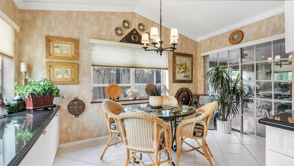 7844 Travelers Tree Drive Boca Raton, FL 33433 - Photo 13 of 40 a dining room with furniture and floor to ceiling windows